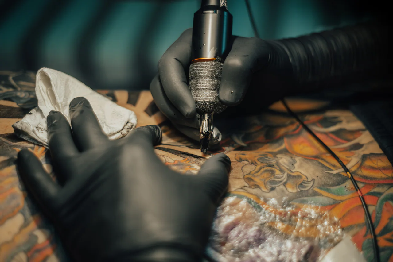 Tattoo artist working with a tattoo machine